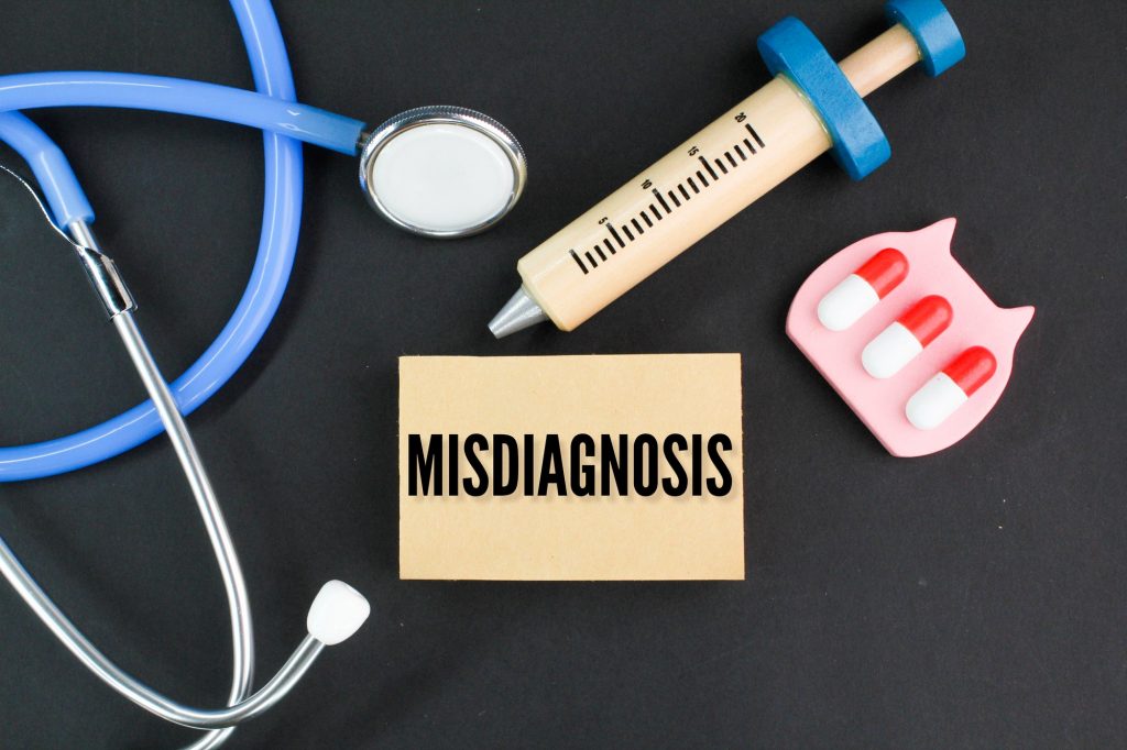 stethoscope, needle shape and medicine with the word Misdiagnosis